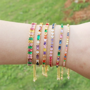 Close-up of colorful zircon tennis bracelets on wrist with adjustable gold-plated chain
