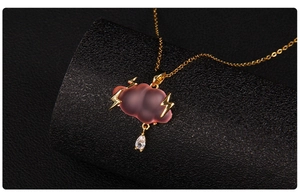 Detail of a pink matte cloud pendant with gold lightning and a water drop zircon