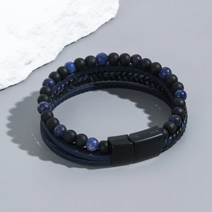 Macro shot of men's multi-layer bracelet with obsidian beads and blue woven leather