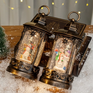 Vintage bronze Christmas lanterns with snowman scene and warm LED light, set of two