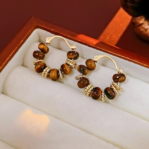 Vintage gold plated hoop earrings with brown tiger eye stone beads in a gift box