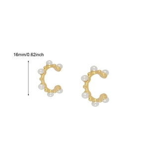 Detail showing 16mm gold C-shape ear cuffs with seven white pearls on white background