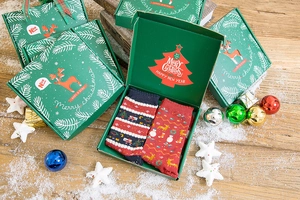 Close-up of Christmas sock gift set with Santa and reindeer patterns in festive box