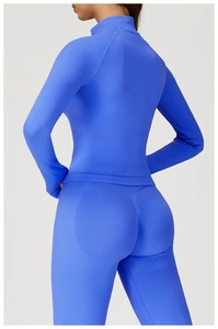 Detail of royal blue seamless knitted yoga set with high collar and athletic texture