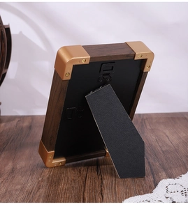 Rear view of walnut wood jewelry display tray with golden corners and foldable stand