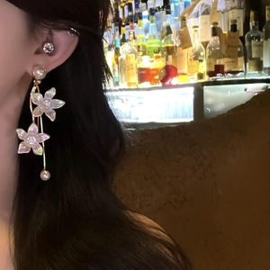 Elegant long fringe earrings with iridescent flowers and white pearls on a model