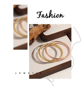 Detailed view of three-color minimalist 4mm solid bangles in gold, silver, and rose gold