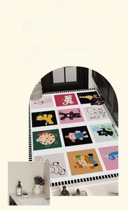 Detail of cartoon patterned absorbent bath mat showing cute rabbit and dinosaur designs