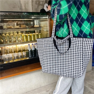 Detail view of checkerboard tote bag with dual straps and large capacity for women
