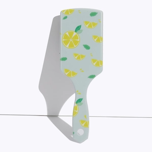 Vertical view of light blue square air cushion hair brush with lemon pattern print