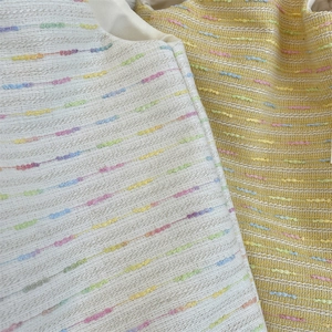 Close-up of rainbow striped tweed texture on stylish knit shoulder bag for women