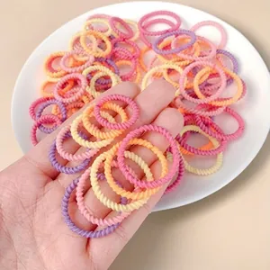 Detail of colorful candy-colored twisted hair ties for babies showing high-elastic texture