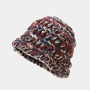 Close-up of thick mixed-color knit texture on winter bucket hat with crochet patterns