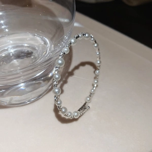 Close-up of double-layered silver pearl bracelet with sparkling pavé rhinestones