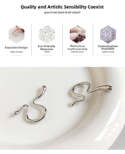 Macro detail of silver irregular curved ear cuffs in high polish copper material