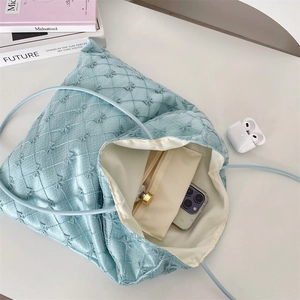 Top view of spacious light blue quilted tote bag showing interior capacity and lining