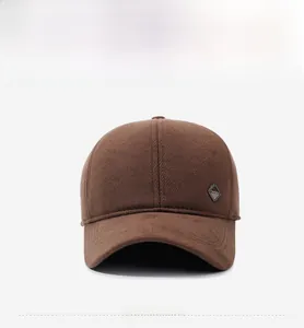 Close-up of thick brown wool baseball cap with decorative metal Fashion badge detail