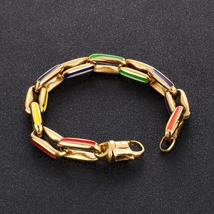 Detail of gold Cuban bracelet with vibrant multi-color enamel inlay and lobster clasp