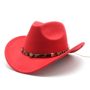 Detail of red wool felt cowboy hat with leopard print band and gold star accessories