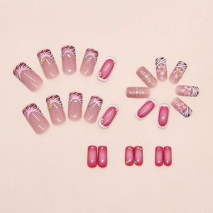 Detail of press-on nail set featuring 3D floral designs and pink leopard print patterns