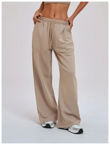 Detail view of khaki wide-leg sweatpants featuring drawstring elastic waistband and soft fabric