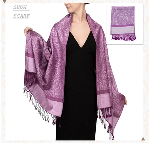 Close-up of luxury purple Paisley shawl with long fringe details and jacquard texture