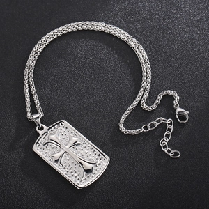 Silver square cross pendant necklace with hammer texture on black textured background