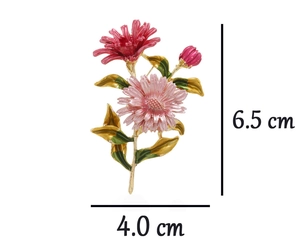 Close-up of pink enamel daisy brooch with gold trim and size dimensions of 6.5 cm by 4.0 cm