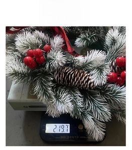 Macro detail of Christmas wreath showing 219.7g weight on a scale for shipping precision
