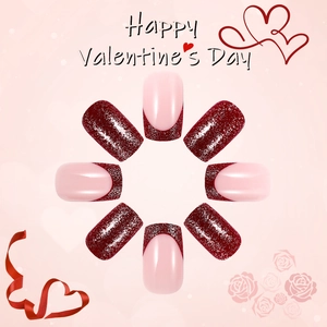 Short square press-on nails featuring red glitter heart designs for Valentine's Day style