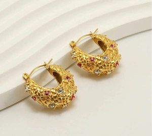 Detail of 18k gold plated hoop earrings with woven texture and sparkling zircon stones