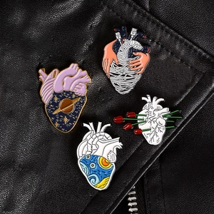 Artistic metal enamel pins featuring heart motifs with starry sky and rose designs