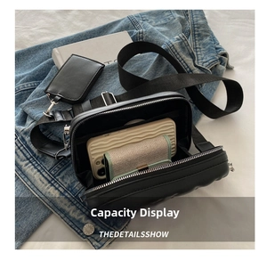 Top view of black crossbody bag interior showing phone and wallet storage space