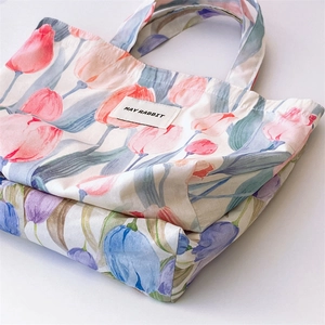 Detailed close-up of tulip printed canvas handbags with May Rabbit woven label
