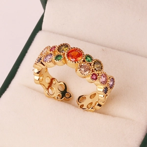 Close-up of golden adjustable ring with rainbow cubic zirconia in a jewelry gift box