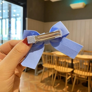 Light blue floral fabric bow hair clip with a durable metal alligator clamp back
