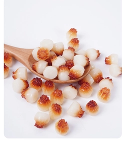 Detailed macro shot of realistic PVC miniature shumai on a wooden spoon accessory