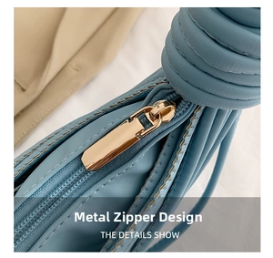 Detailed macro view of smooth golden zipper and sky blue leather texture on shell bag