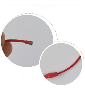 Detailed macro view of red coated stainless steel wire keychain with screw lock mechanism