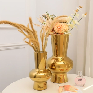 Modern light luxury set of two shiny gold ceramic vases for elegant home decoration