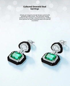 Macro view of emerald lab-grown stud earrings with green stone and black enamel