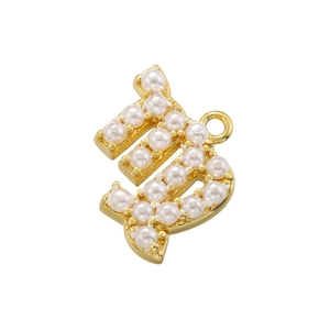 Macro shot of gold-plated letter B pendant featuring delicate white pearl inlays