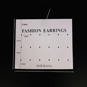 Detailed view of white PVC jewelry display card with 12 and 18 earring hole patterns