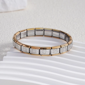 Detail of Italian charm bracelet links featuring embossed daisy patterns in gold and silver