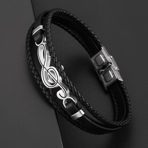 Detail of multi-layer black braided leather bracelet with silver musical note charm