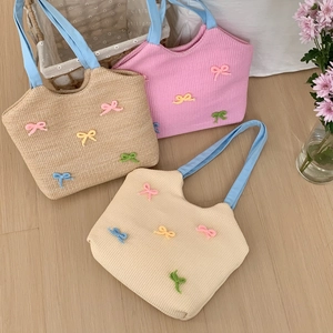 Handwoven straw shoulder bags in three colors with colorful crochet bow accessories