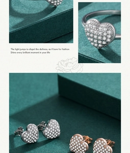 Detail of heart-shaped jewelry set with crystal stones in silver and rose gold
