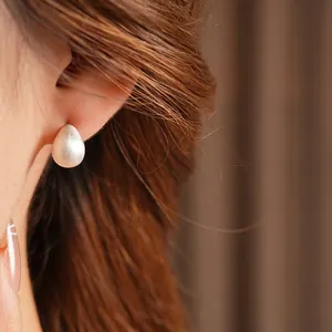 Minimalist matte silver teardrop earrings with a brushed metallic texture for women
