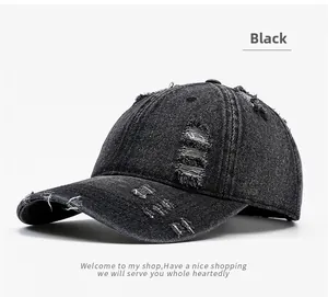 Close-up of distressed black washed denim baseball cap with vintage ripped details
