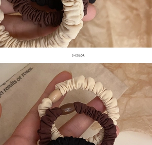 Close-up of 3-pack scrunchies in beige, brown, and black with smooth resin cylinders